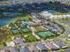 Aerial view showcasing the community pool, tennis courts, clubhouse, and surrounding residences at 31510 Cabana Rye Ave, San Antonio, FL 33576