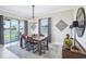 Dining room with stylish table, chairs, light fixture, decor, and sliding glass doors to the patio at 31510 Cabana Rye Ave, San Antonio, FL 33576