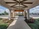 Inviting entrance with decorative stone pillars, lush landscaping, and a covered walkway at 31510 Cabana Rye Ave, San Antonio, FL 33576