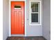 Inviting front entrance with a bright orange door and welcome mat at 31510 Cabana Rye Ave, San Antonio, FL 33576
