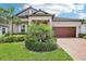 Landscaped front yard and a red front door that adds a pop of color to the home's exterior at 31510 Cabana Rye Ave, San Antonio, FL 33576