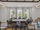 Game room featuring poker table, chairs, modern lighting, and windows overlooking landscaped greenery at 31510 Cabana Rye Ave, San Antonio, FL 33576