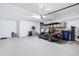 View of a clean, well-lit garage with epoxy floors, storage cabinets, and space for multiple vehicles at 31510 Cabana Rye Ave, San Antonio, FL 33576
