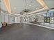 Large gym featuring mirrors, high ceilings, rubber floor, multiple doors and large windows at 31510 Cabana Rye Ave, San Antonio, FL 33576