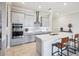 Modern kitchen with an island, stainless steel appliances, and grey cabinetry at 31510 Cabana Rye Ave, San Antonio, FL 33576