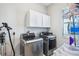 Efficient laundry room with modern washer, dryer, and overhead cabinets at 31510 Cabana Rye Ave, San Antonio, FL 33576