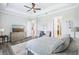 Spacious bedroom featuring tray ceiling, gray wood floors, and a large bed at 31510 Cabana Rye Ave, San Antonio, FL 33576