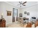 A bright home office is furnished with a wooden desk and is decorated with two framed pictures at 31510 Cabana Rye Ave, San Antonio, FL 33576
