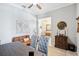 A home office is furnished with a wooden table and a cozy brown sofa and decorated with a world map at 31510 Cabana Rye Ave, San Antonio, FL 33576
