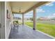 Comfortable covered patio with tiled flooring, seating, ceiling fan, and lovely backyard view at 31510 Cabana Rye Ave, San Antonio, FL 33576