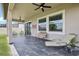 Charming covered patio with ample seating and a ceiling fan, perfect for outdoor relaxation at 31510 Cabana Rye Ave, San Antonio, FL 33576