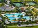 A stunning aerial view of the resort-style pool with palm trees, cabanas, and sun loungers at 31510 Cabana Rye Ave, San Antonio, FL 33576