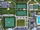 Bird's-eye view of tennis courts, shuffleboard, and a bocce ball court in a planned community at 31510 Cabana Rye Ave, San Antonio, FL 33576