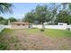 This backyard offers a large grassy area with a small shed and white vinyl fencing at 3303 W Ballast Point Blvd, Tampa, FL 33611