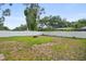 The backyard offers a grassy area surrounded by a white fence for privacy at 3303 W Ballast Point Blvd, Tampa, FL 33611