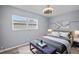This bedroom offers a ceiling fan, one window, and tasteful decor throughout at 3303 W Ballast Point Blvd, Tampa, FL 33611