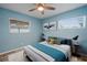 This bedroom has a ceiling fan, two windows, two bedside tables, and tasteful decor at 3303 W Ballast Point Blvd, Tampa, FL 33611