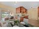 Cozy dining area with stylish table setting, adjacent to a kitchen with wood cabinets and a view of the outdoor patio at 3303 W Ballast Point Blvd, Tampa, FL 33611