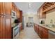 Well-equipped kitchen featuring stainless steel appliances, granite countertops, and ample cabinet space at 3303 W Ballast Point Blvd, Tampa, FL 33611