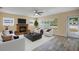 Bright living room featuring a fireplace, lots of natural light, and stylish furniture at 3303 W Ballast Point Blvd, Tampa, FL 33611