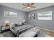 Relaxing primary bedroom with a ceiling fan, lots of natural light, and modern decor at 3303 W Ballast Point Blvd, Tampa, FL 33611