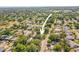Overhead view showcasing neighborhood with lush greenery and nearby community amenities at 331 Archimedes St, Dunedin, FL 34698