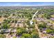 Overhead view showcasing neighborhood with lush greenery and nearby community amenities at 331 Archimedes St, Dunedin, FL 34698