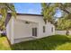 Inviting covered back patio, perfect for outdoor entertaining, with a grassy backyard at 331 Archimedes St, Dunedin, FL 34698