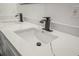Bathroom vanity featuring double sinks, a quartz countertop and matte black faucets at 331 Archimedes St, Dunedin, FL 34698