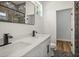 Modern bathroom with double vanity, quartz countertops, and separate shower at 331 Archimedes St, Dunedin, FL 34698