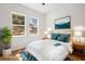 Bright bedroom with a queen bed, wood floors, and scenic views from large windows at 331 Archimedes St, Dunedin, FL 34698