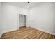Neutral bedroom featuring wood floors, white trim, and a window at 331 Archimedes St, Dunedin, FL 34698