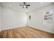 Spacious bedroom with light wood flooring and two windows providing natural light at 331 Archimedes St, Dunedin, FL 34698