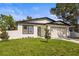Beautiful single-story house with a well-kept yard and an attached garage at 331 Archimedes St, Dunedin, FL 34698