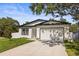 Beautiful single-story house with a well-kept yard and an attached garage at 331 Archimedes St, Dunedin, FL 34698