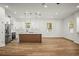 Bright and open kitchen with modern appliances, a large island, and wood-look flooring at 331 Archimedes St, Dunedin, FL 34698