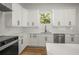 Bright kitchen boasts white cabinets, stainless steel appliances, and stylish finishes, creating a modern culinary space at 331 Archimedes St, Dunedin, FL 34698