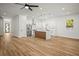Bright and open kitchen with modern appliances, a large island, and wood-look flooring at 331 Archimedes St, Dunedin, FL 34698