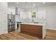 Modern kitchen featuring sleek countertops, stainless steel appliances, a kitchen island, and ample cabinet space at 331 Archimedes St, Dunedin, FL 34698