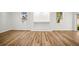 Open living room with wood-look flooring, recessed lighting, and large windows at 331 Archimedes St, Dunedin, FL 34698