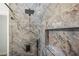 Stunning shower featuring luxurious marble-look tile and a modern rainfall shower head at 331 Archimedes St, Dunedin, FL 34698