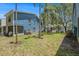 Inviting exterior view of a blue townhome showcasing the lush green lawn and mature landscaping at 3343 Fox Hunt Dr, Palm Harbor, FL 34683