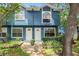 Charming blue townhouse with well-maintained landscaping and inviting front entrance at 3343 Fox Hunt Dr, Palm Harbor, FL 34683