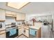 Well-lit kitchen with stainless steel appliances and a view into the open living area at 3343 Fox Hunt Dr, Palm Harbor, FL 34683