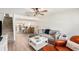 Open-concept living room flows into the dining area, featuring modern furnishings and a staircase at 3343 Fox Hunt Dr, Palm Harbor, FL 34683
