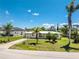 Aerial view of a well-maintained property with a lush lawn, mature palm trees, and a long driveway leading to the house at 3420 Santa Clara Dr, Punta Gorda, FL 33983
