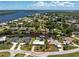 Waterfront home features a boat dock, a metal roof, and verdant tropical landscaping at 3420 Santa Clara Dr, Punta Gorda, FL 33983