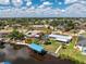 Waterfront home features a boat dock, a metal roof, and verdant tropical landscaping at 3420 Santa Clara Dr, Punta Gorda, FL 33983