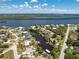 An aerial view of a waterfront home encircled in red, featuring a private boat dock and beautiful canal access to the bay at 3420 Santa Clara Dr, Punta Gorda, FL 33983