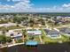 Waterfront home features a boat dock, a metal roof, and verdant tropical landscaping at 3420 Santa Clara Dr, Punta Gorda, FL 33983